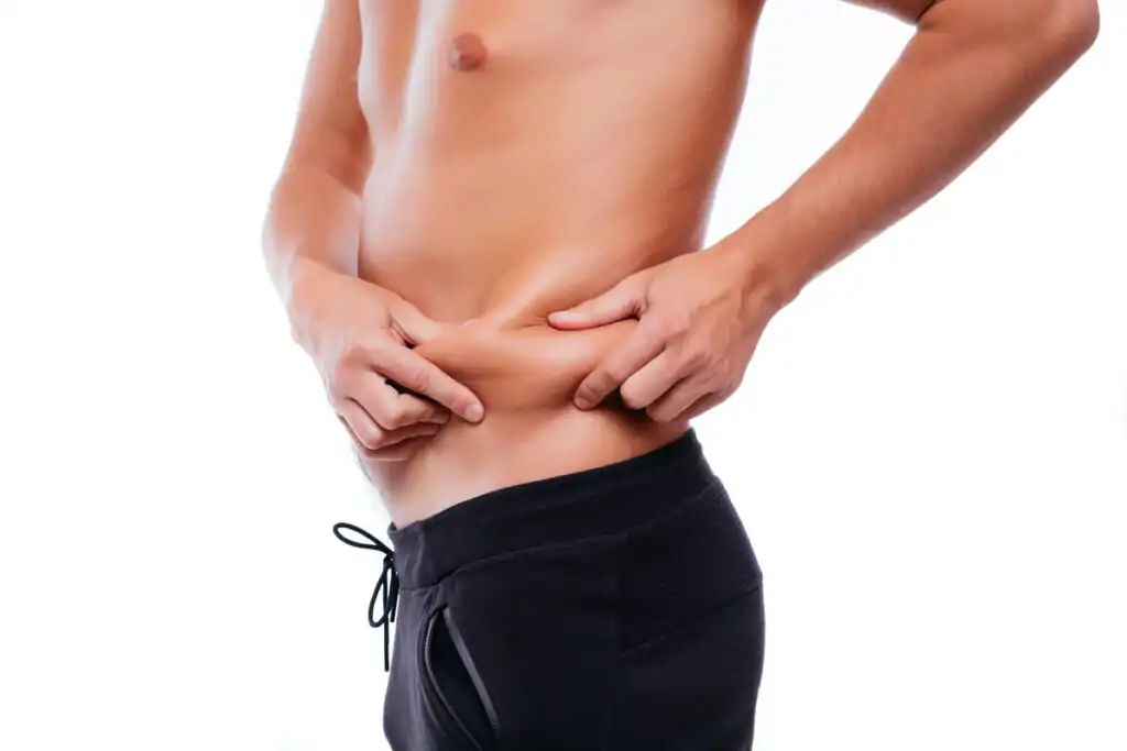 A man holding his belly fat, considering plastic surgery