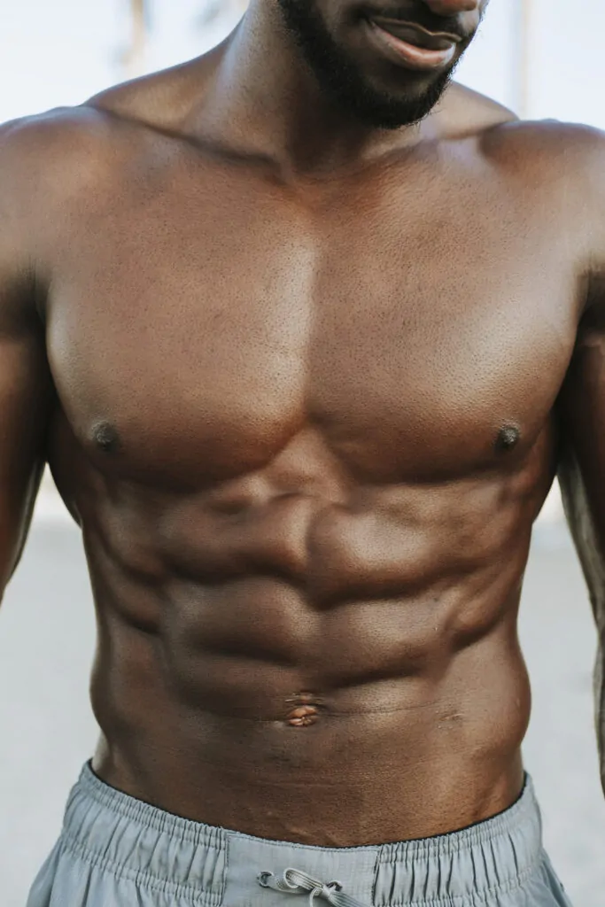 Close up of abs on a fit man after abdominal etching