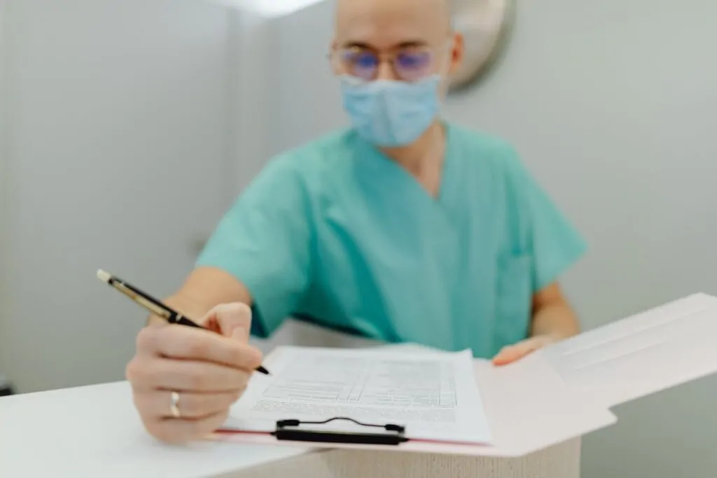 A plastic surgeon writing notes about reconstructive surgery