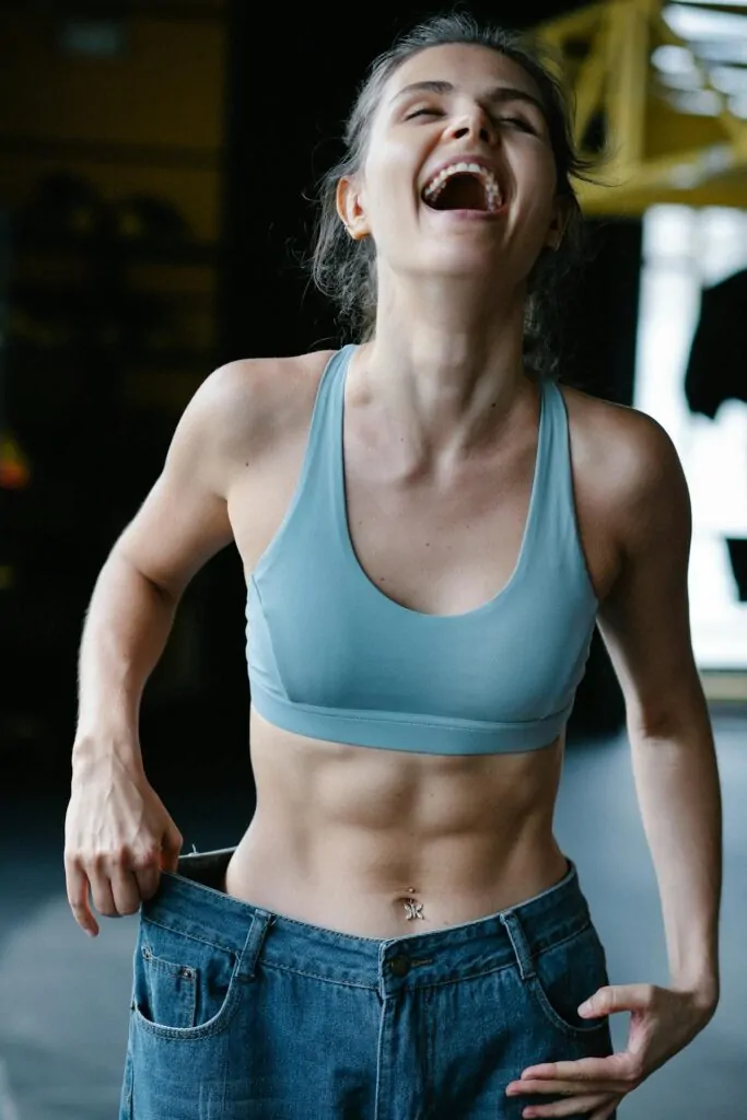 a happy woman getting her abs after a lipo surgery