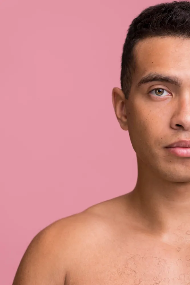 Front view of man posing while showing half of face
