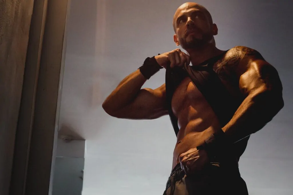 man flexing his abs after liposuction