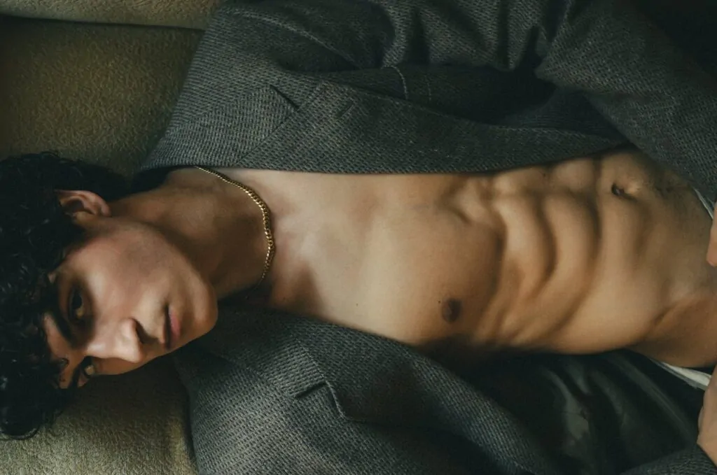 Man flexing his sculpted abdomen after HD liposuction