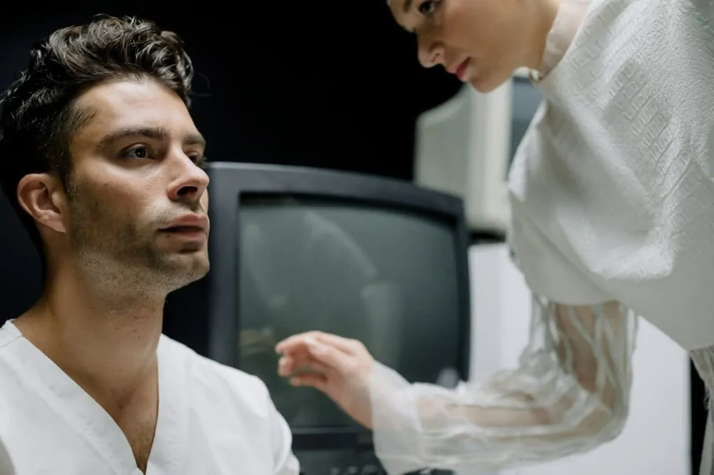 A plastic surgeon inspecting FaceTite patient before surgery
