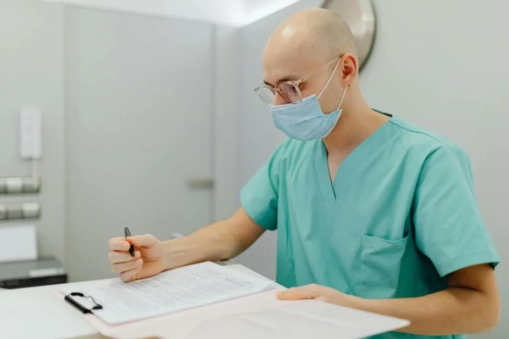 Surgeon writing about liposuction
