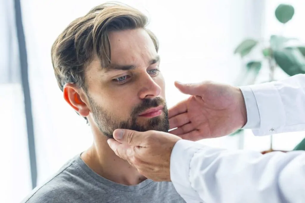 Doctor examining a patients neck