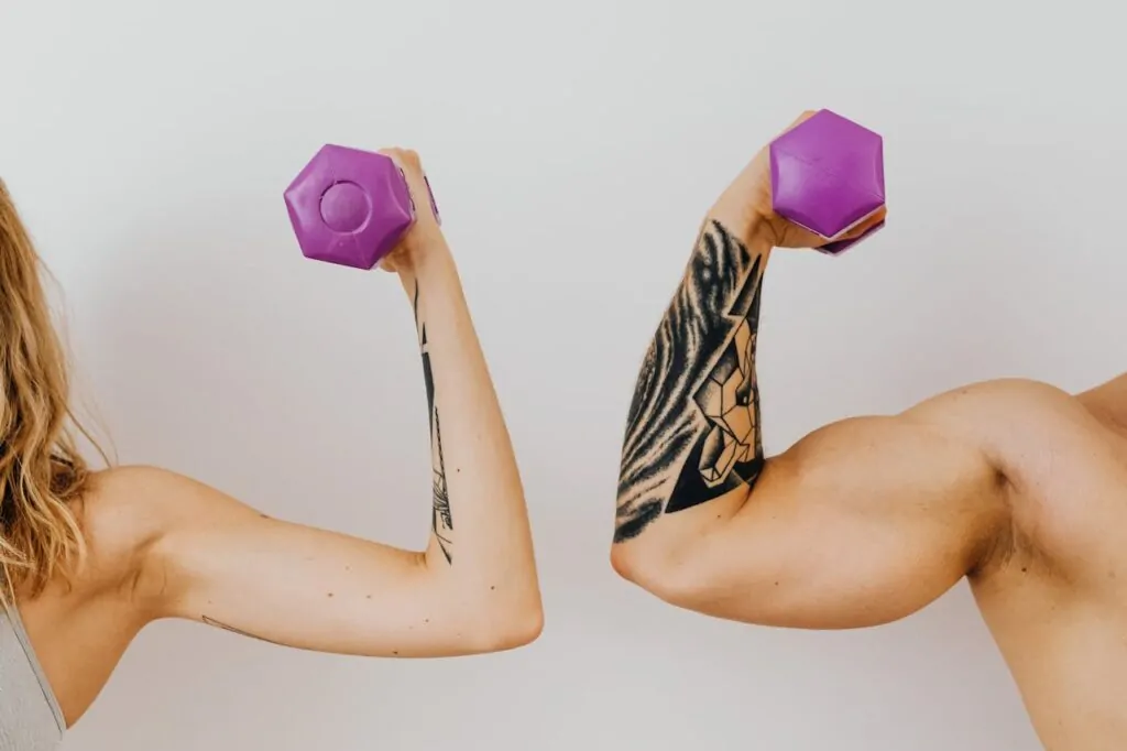 man and woman flexing their arms after surgery recovery