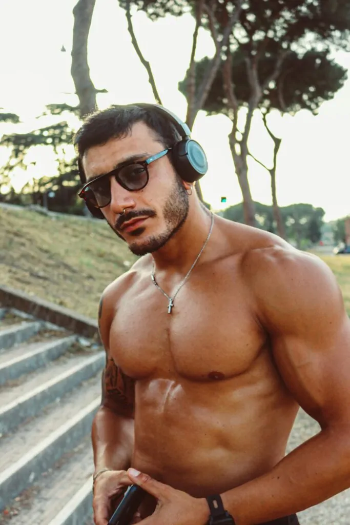 man flexing his muscular body after plastic surgery