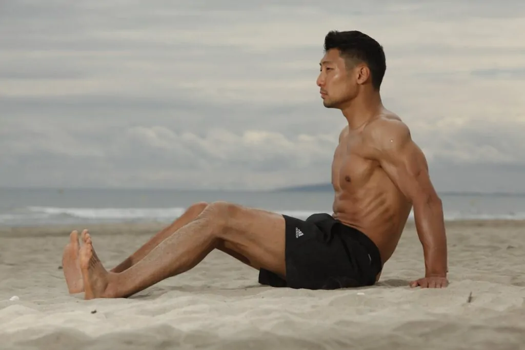 A man with sculpted abdomen after getting a high definition liposuction