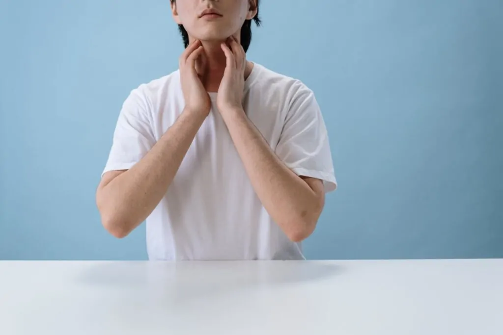 Man inspecting his neck and thinking of getting liposuction