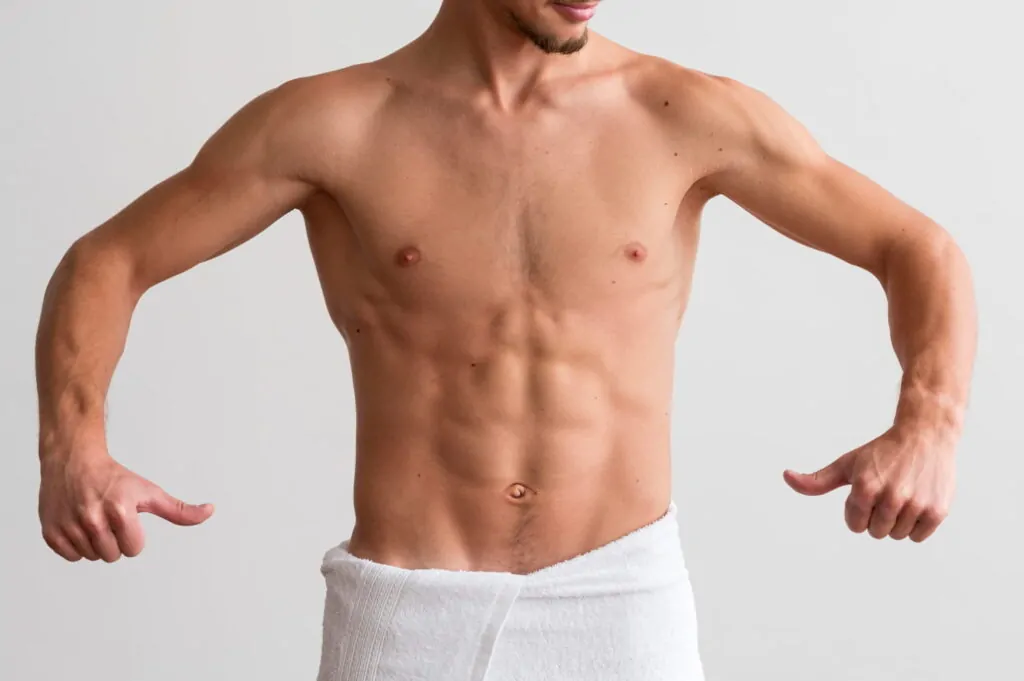 Man showing off his abs after getting HD liposuction