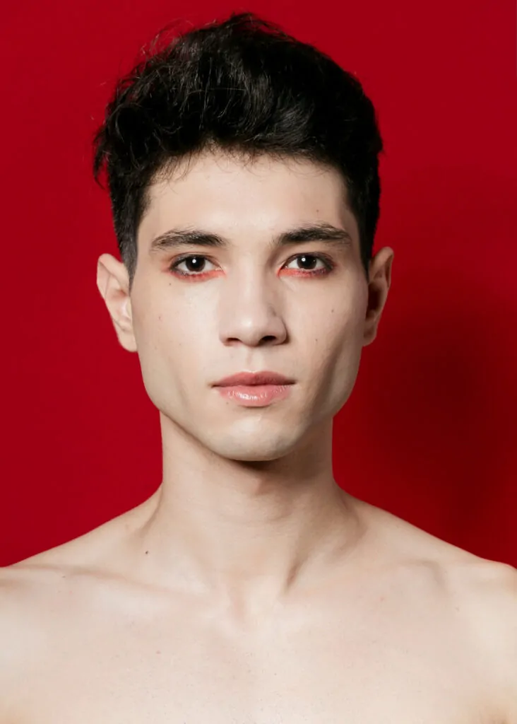 A man wearing make up with defined jawline