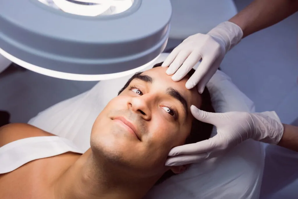 Plastic surgeon doing jawline contouring on a patient