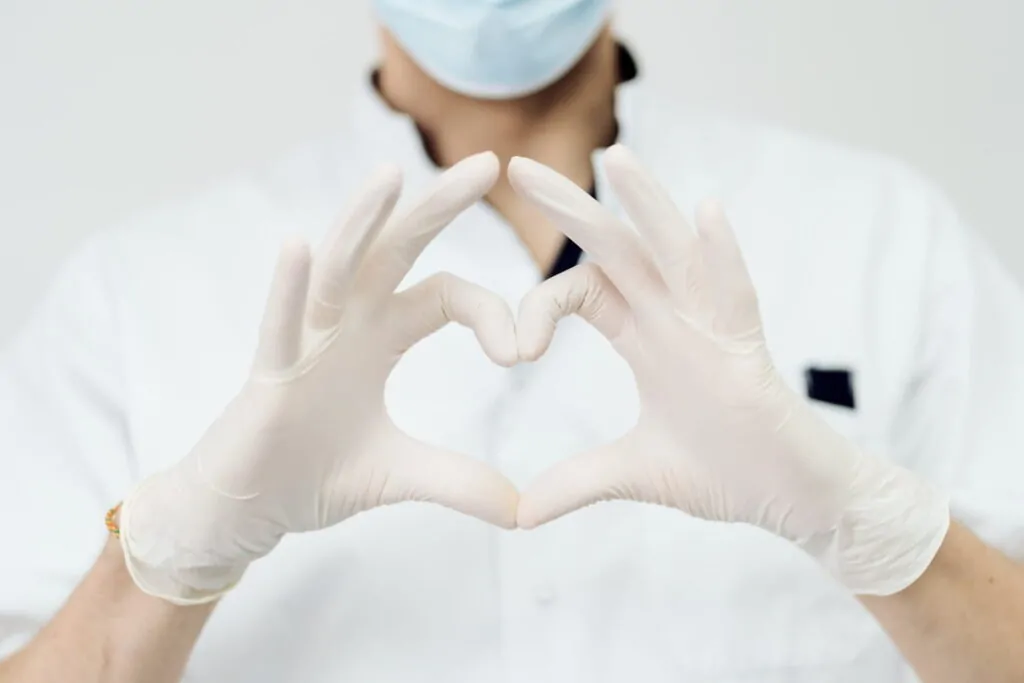 Plastic surgeon doing a heart pose before doing a surgery