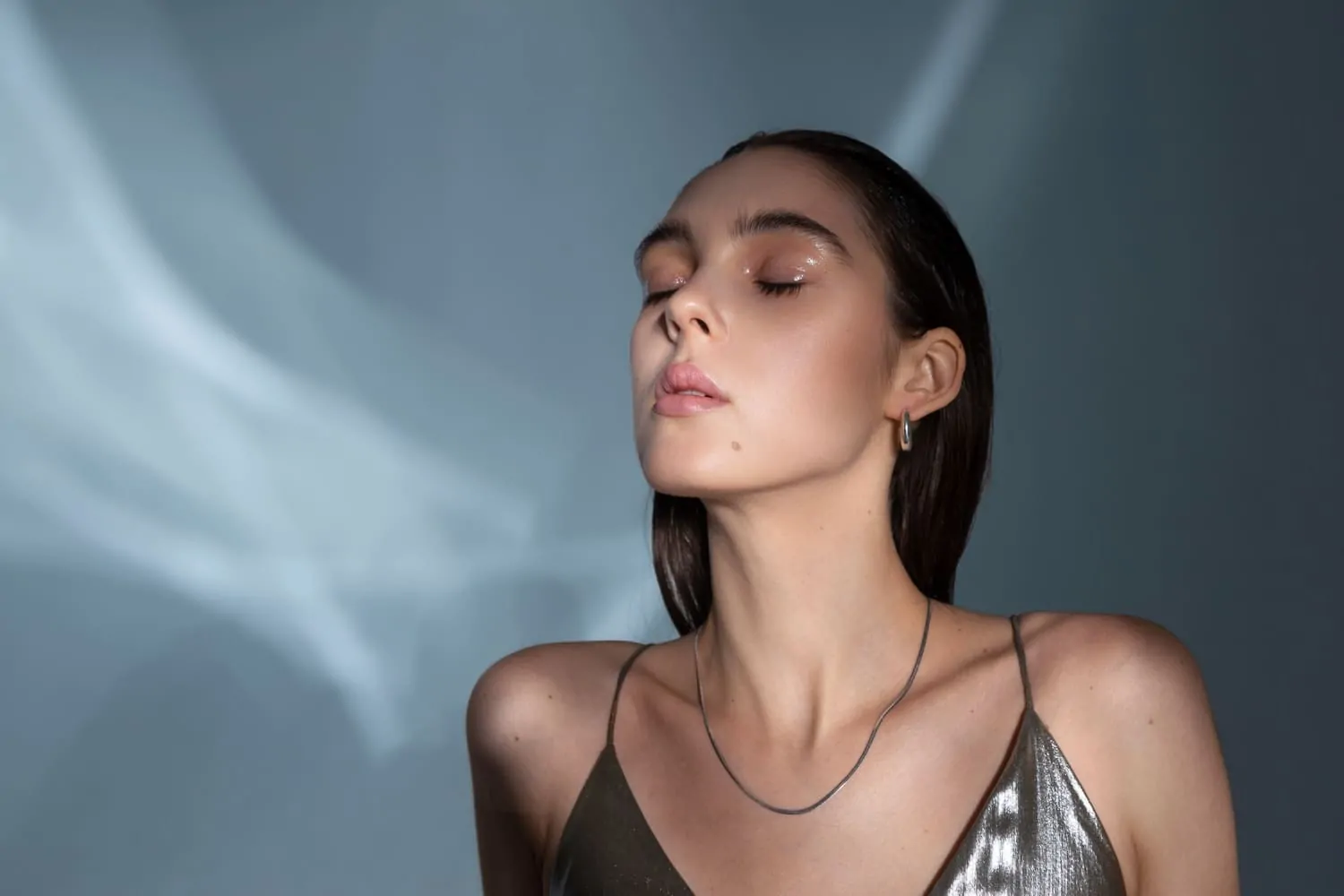 Woman with smooth, lifted facial features and defined neck and jawline showcasing non-surgical facelift results