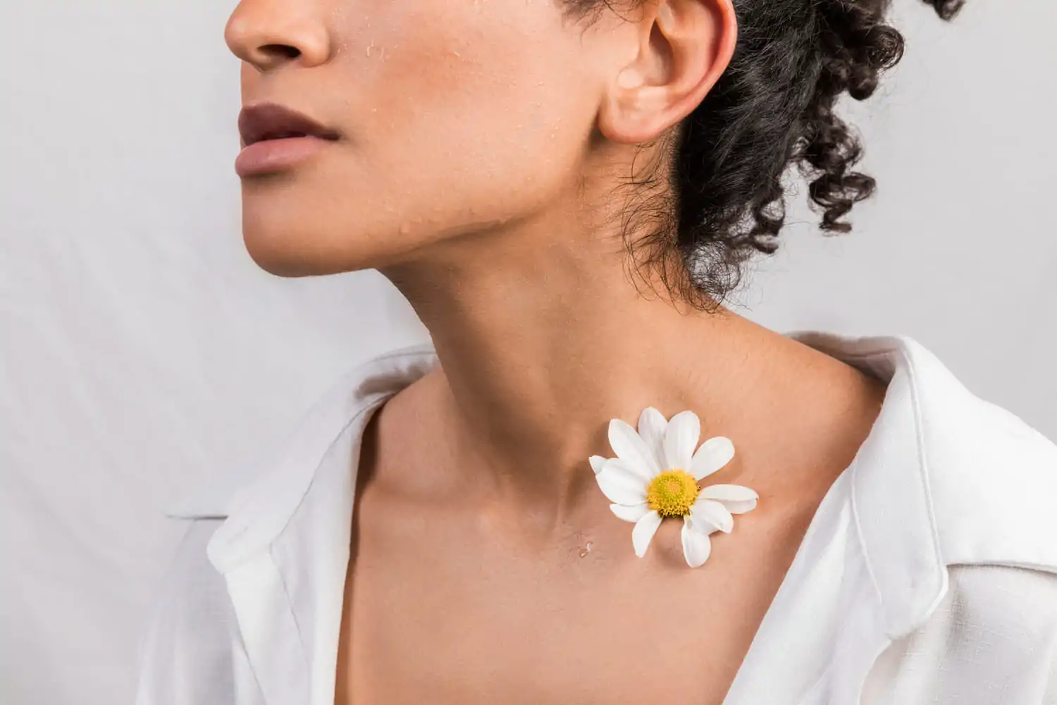 woman with flower on neck