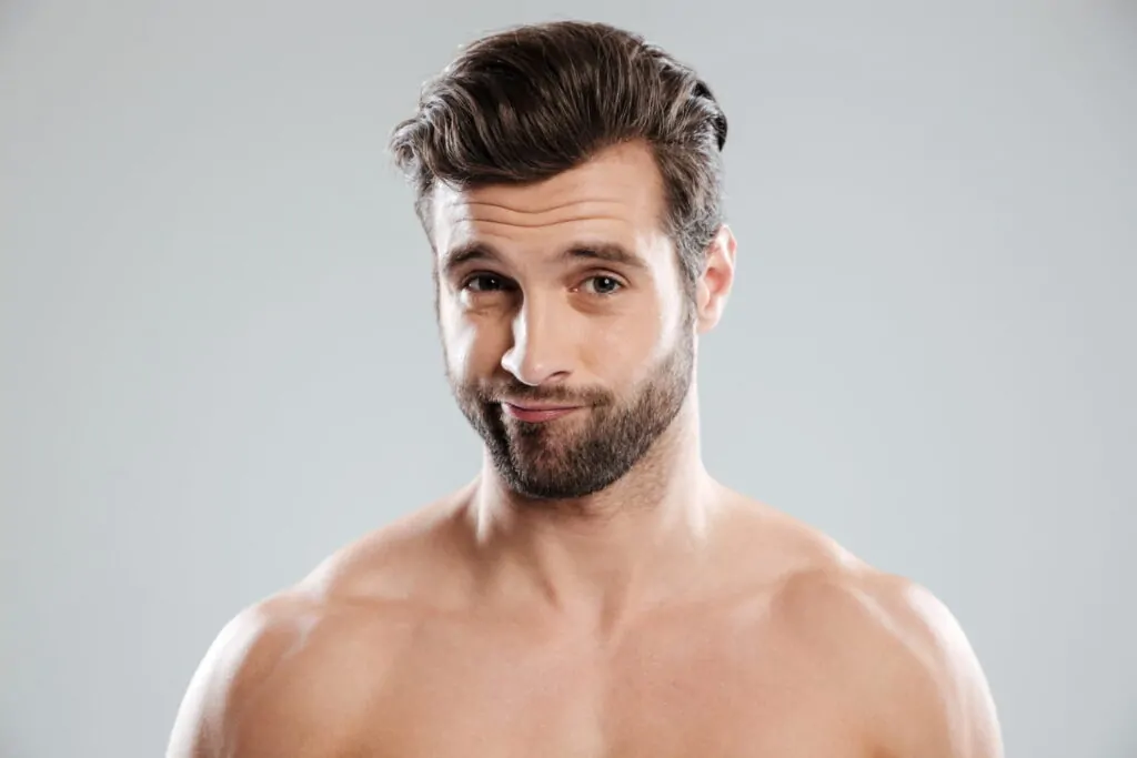Close-up shot of handsome man's face after neck liposuction