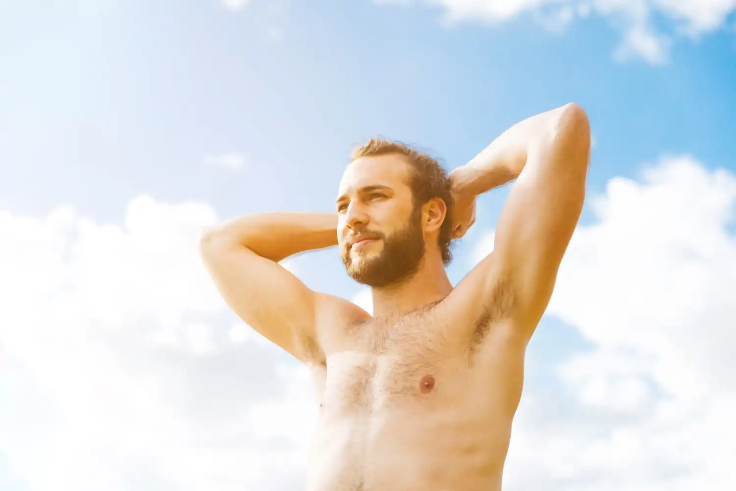 Man posing under the sun after plastic surgery recovery