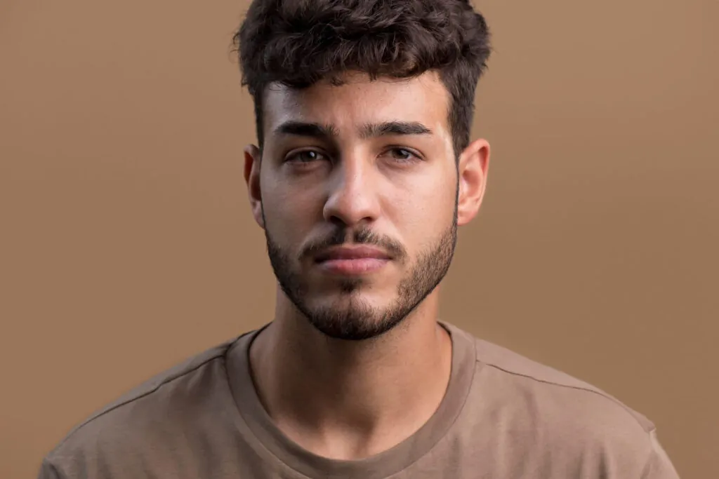 Young man showing natural facial contours and symmetrical features before Botox treatment