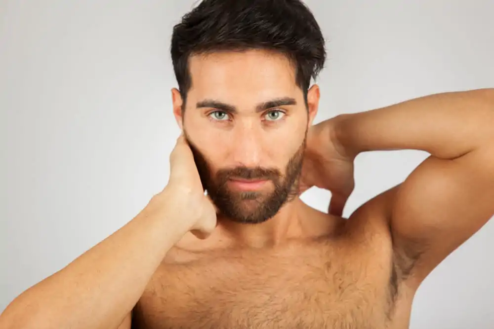 Man flexing his sculpted facial features after neck liposuction