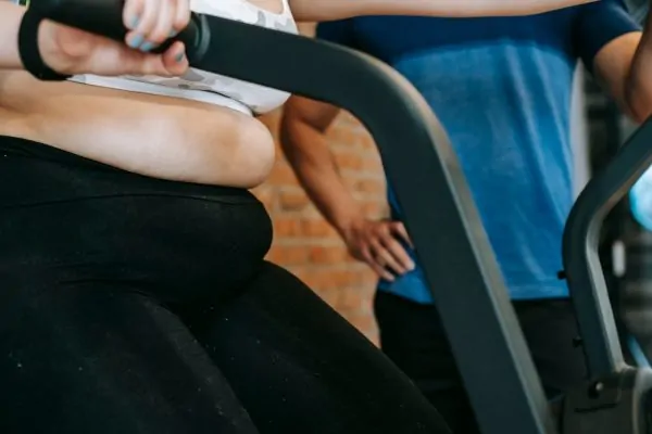 A woman exercising before getting a tummy tuck surgery