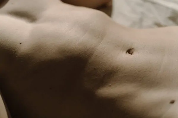 Close-up shot of a stomach after liposuction recovery