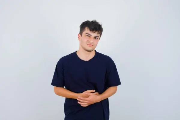 Man hiding his dog ears after his tummy tuck procedure