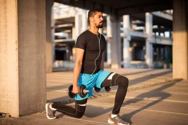 Man listening to music and exercising after liposuction recovery