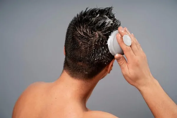 Man massaging his scalp with shampoo after PDO thread lift