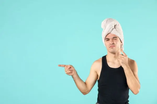 Man with a towel on head thinking of using a warm compress after PDO thread lift
