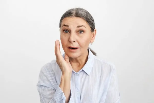 Old woman getting upset over her jowls
