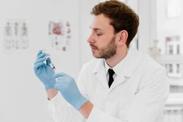 Plastic surgeon holding a syringe and Botox vial