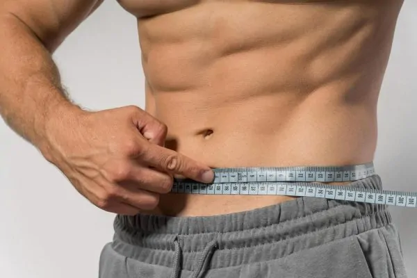 A man measuring his waist.