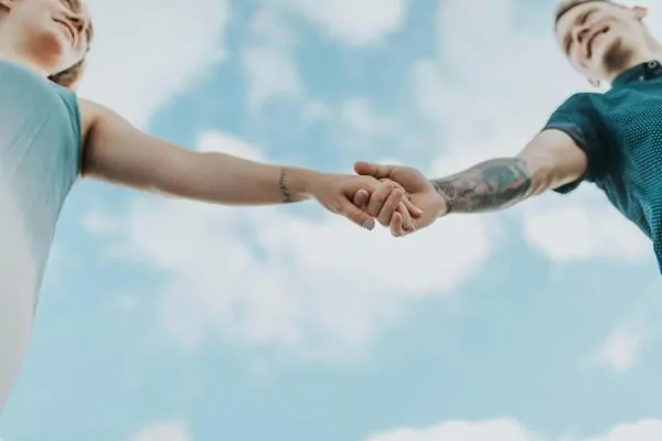 A couple holding each others hands