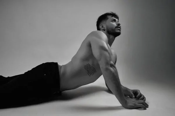 A man posing artistically after a tummy tuck recovery