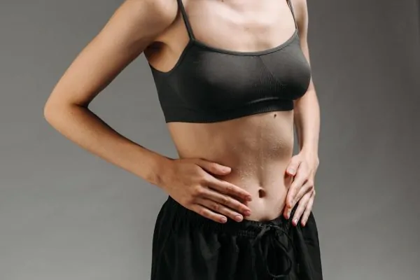 A woman with a flat stomach after liposuction