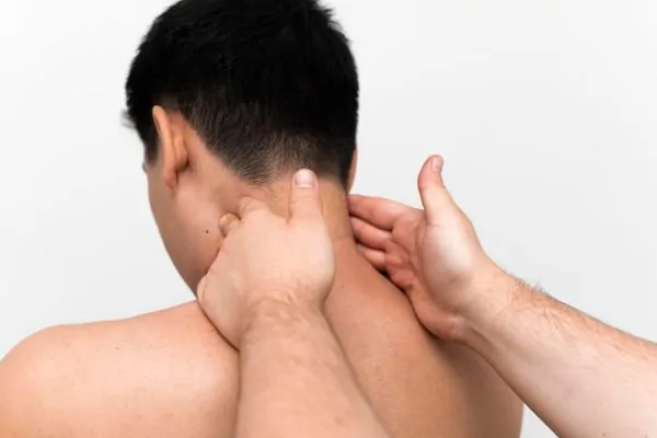 Back view of a man getting a massage after neck liposuction