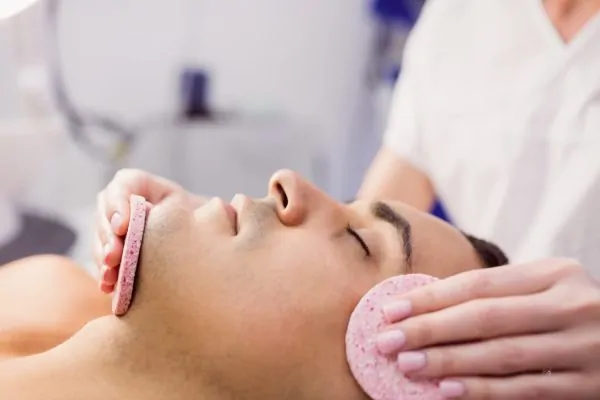 Close-up shot of man getting facial massage before receiving Botox injection