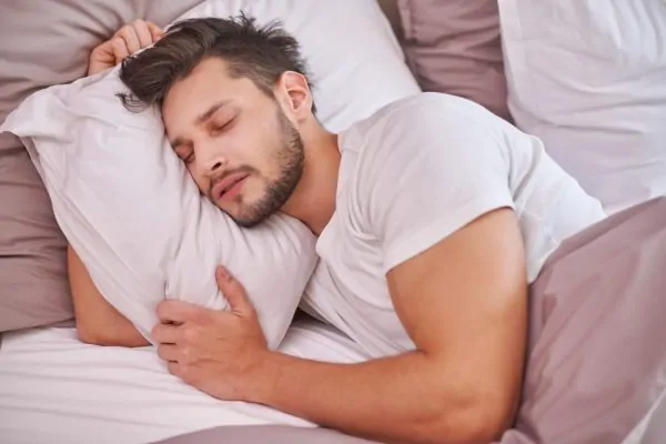 Man sleeping and resting during his liposuction recovery period