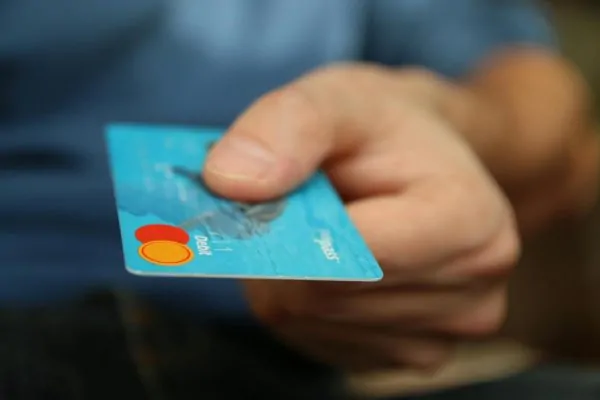 A person handing over the debit card