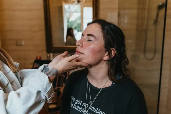 A woman getting her face inspected after undergoing a PDO thread procedure