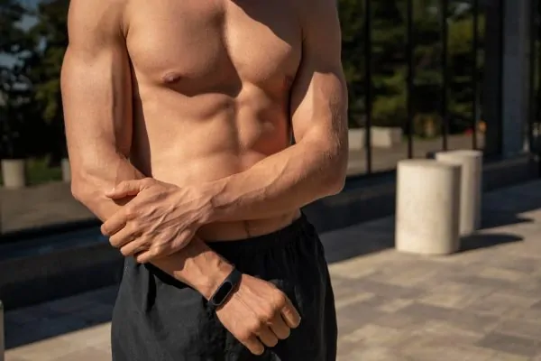 Front view of shirtless man showing off his high definition liposuction results