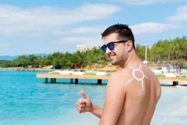 Man applying sunscreen after getting plastic surgery