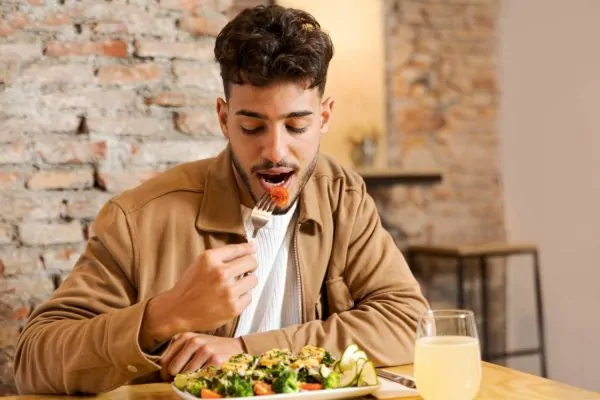 Medium shot man eating healthy food after liposuction