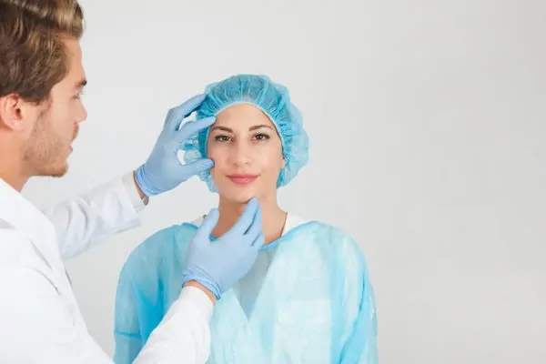 Plastic surgeon checking if a patient is a candidate for peptide therapy