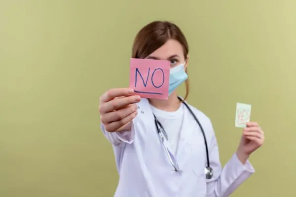 Plastic surgeon showing a note that says no about Hexarelin candidates