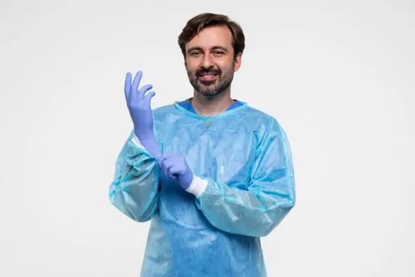 Portrait of plastic surgeon wearing medical gown and gloves before full body liposuction