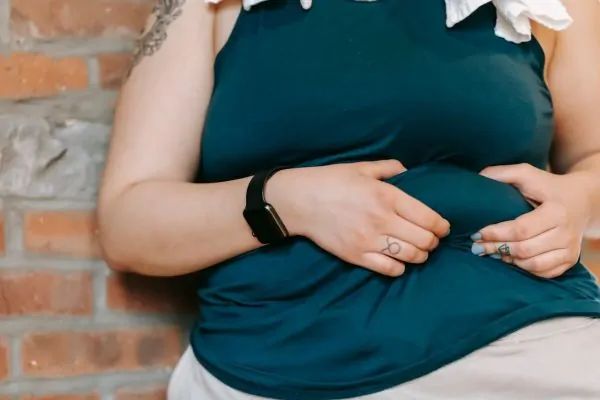 Woman with fat belly before undergoing liposuction