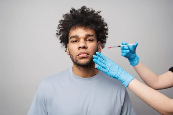 Young man receiving a Botox injection