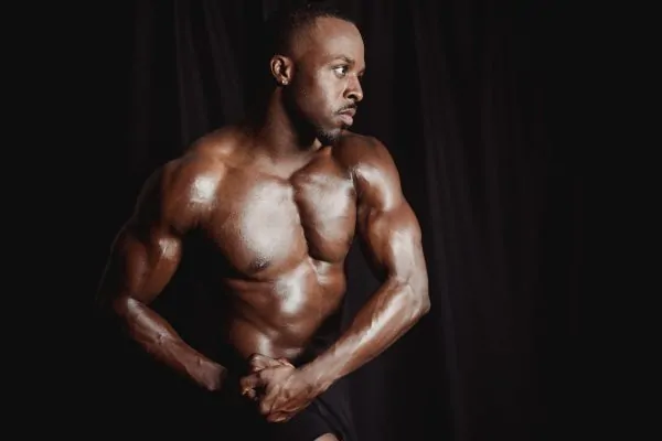 A man posing after his liposuction surgery